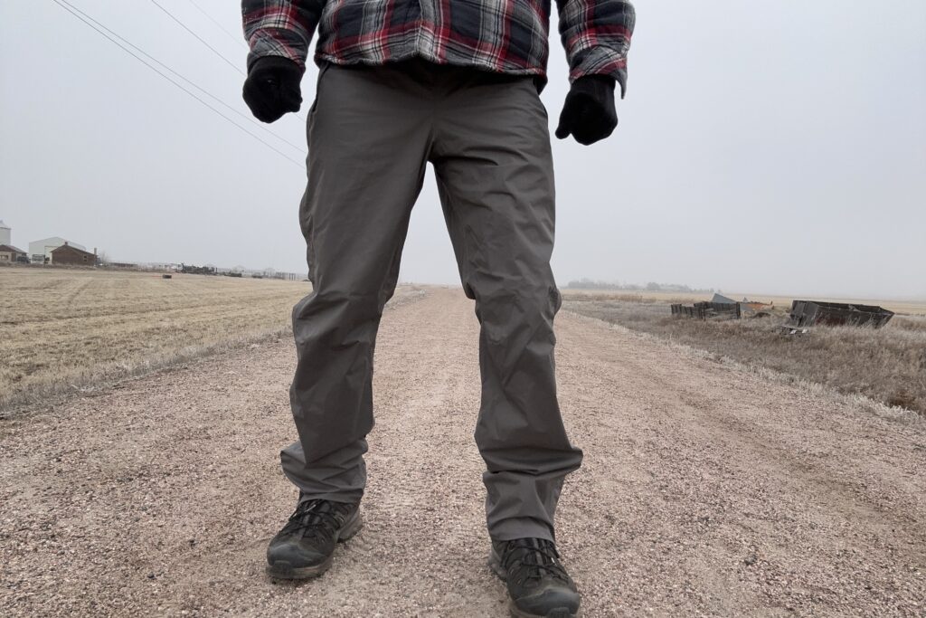 Closeup of someone wearing the REI Rainier rain pants.