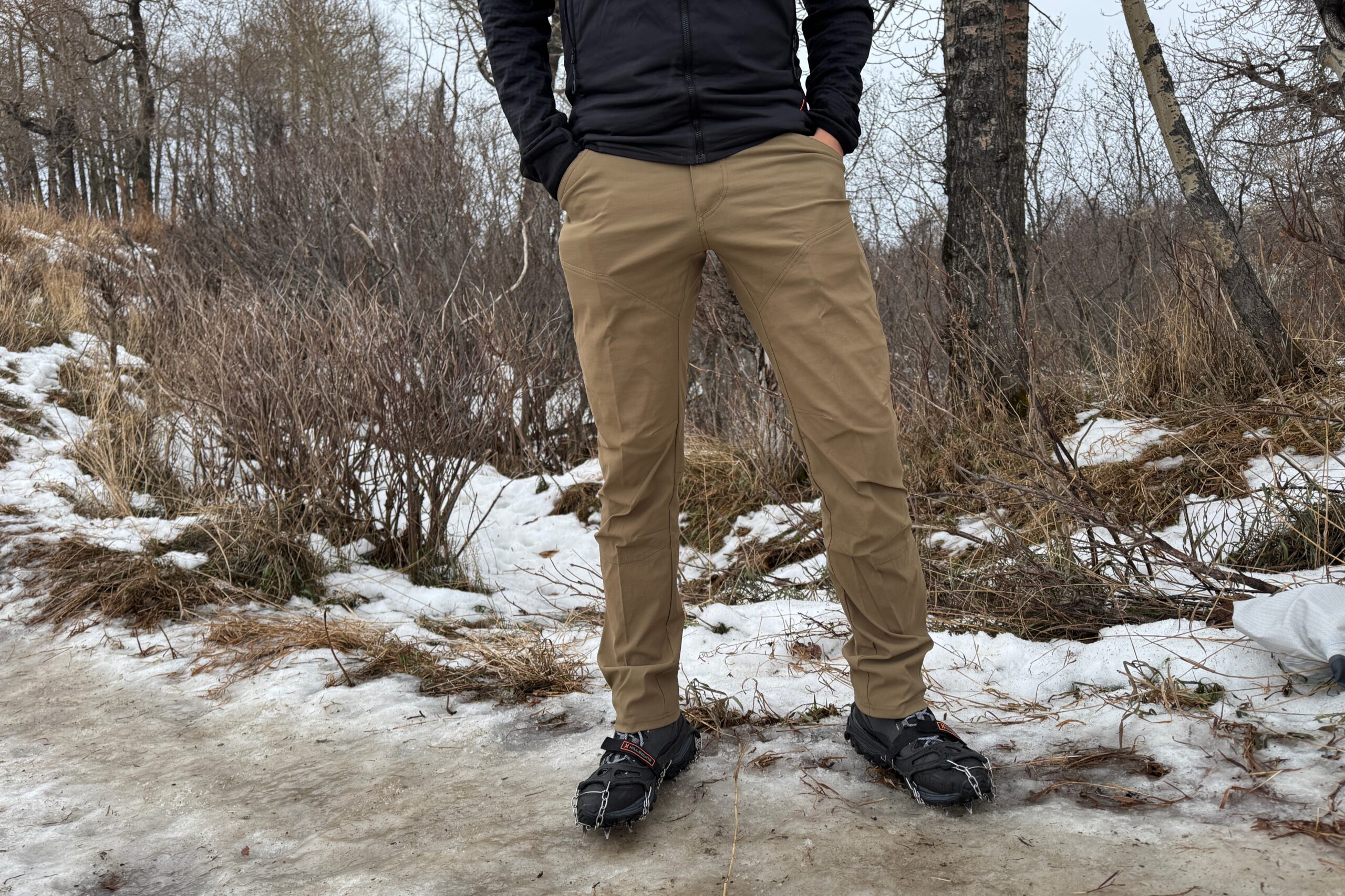 A closeup of the front of pans worn on an icy trail.