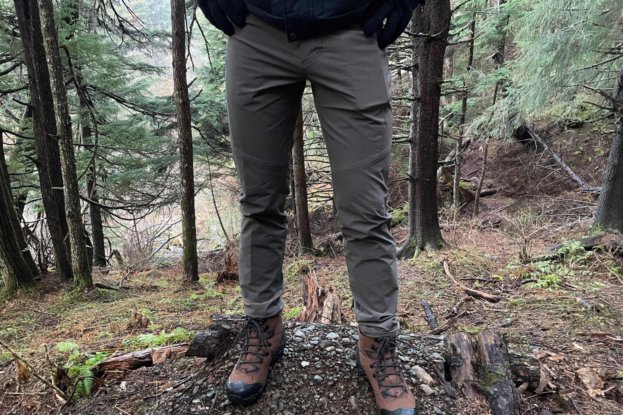 A closeup of hiking pants on a forest trail.