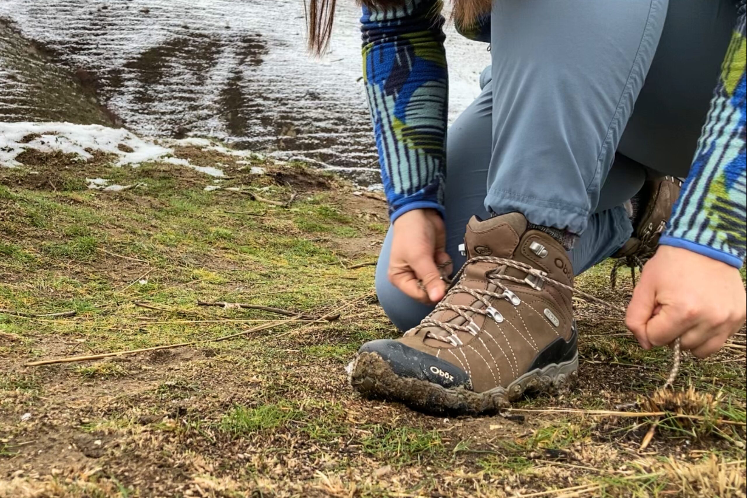 Hiker stopped on the trail to tie her Women’s Oboz Bridger WP hiking boots