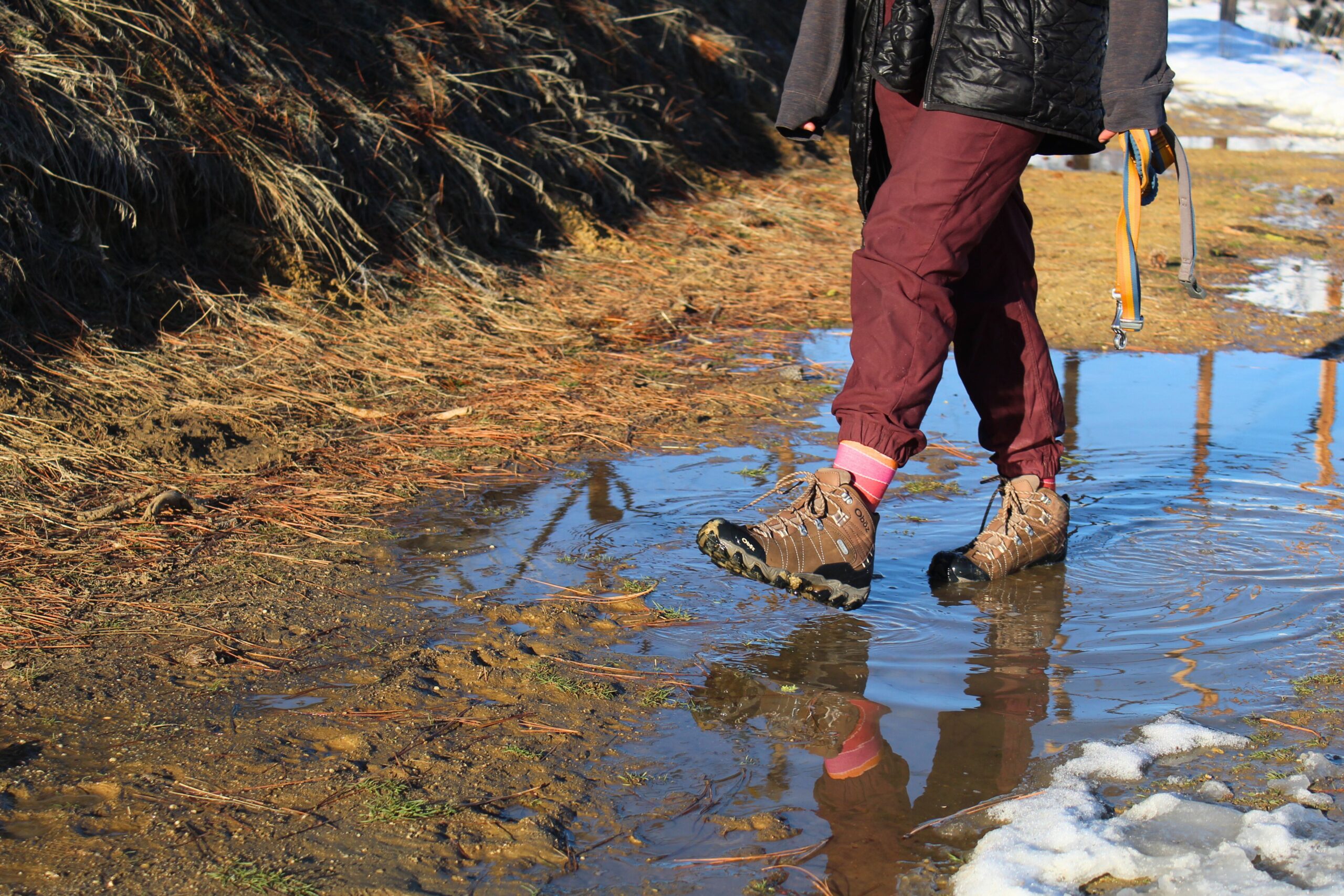 Hiker wearing the Women’s Oboz Bridger WP while walking through a puddle