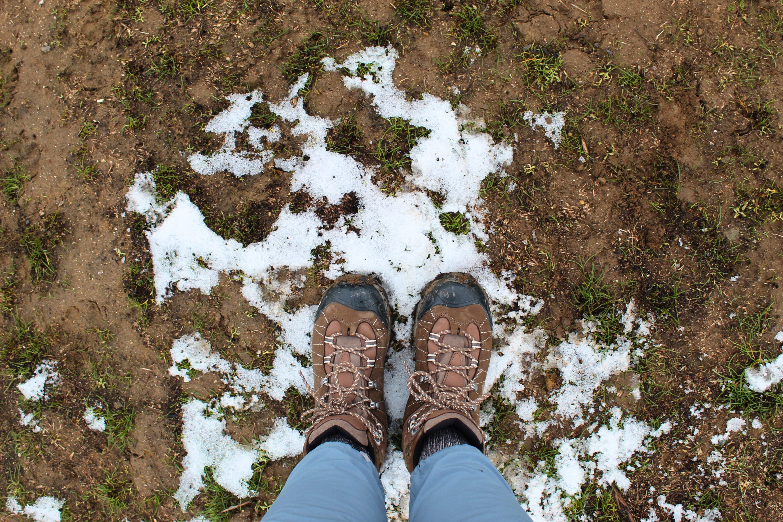 Hiker wearing the Women’s Oboz Bridger WP boots on a small patch of snow