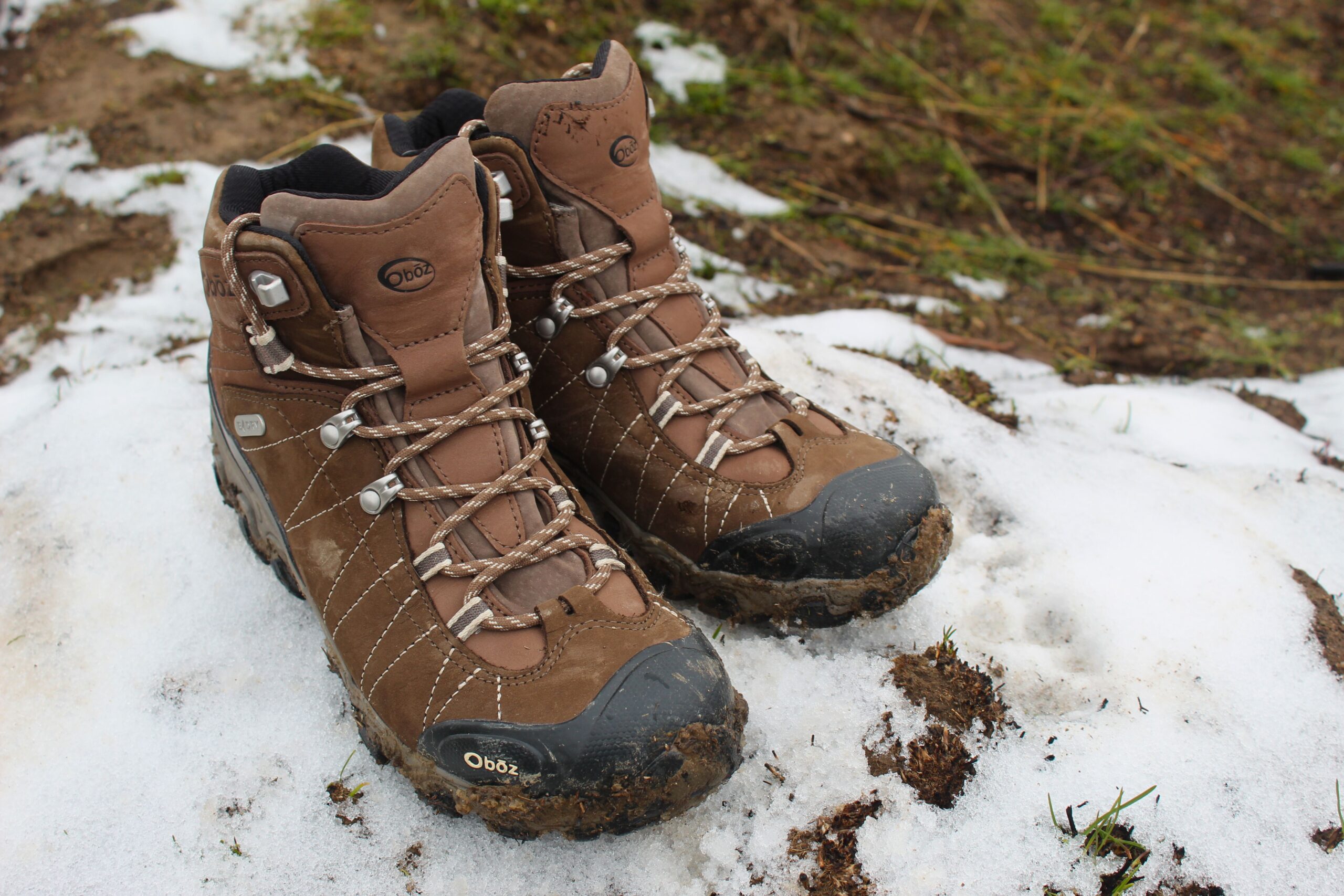 A pair of Women’s Oboz Bridger WP sitting on a patch of snow outside