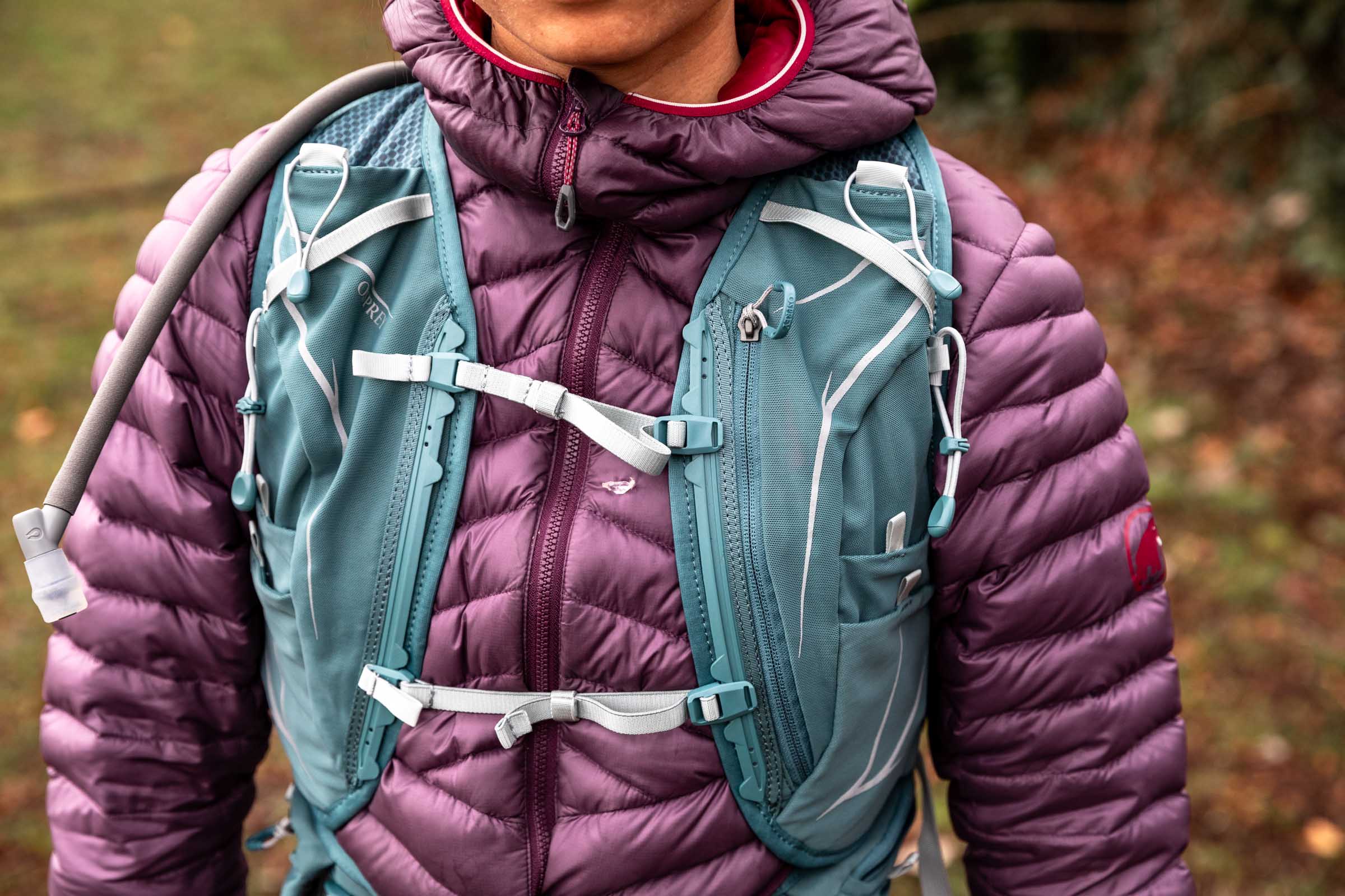 Details of Osprey Dyna 15L - a person is wearing the pack facing towards the camera, showing the shoulder and sternum traps