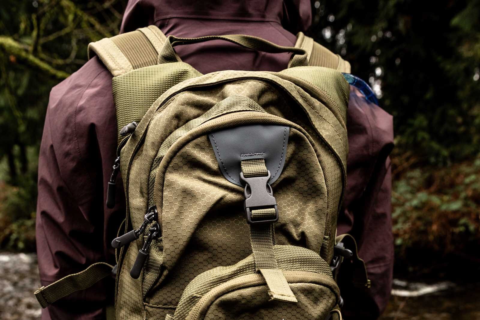 Details of TETON Sports Oasis 18L Hydration Pack - a person wearing the pack looking away