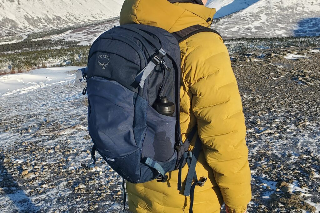 A closeup of the mesh bottle pocket of a backpack.