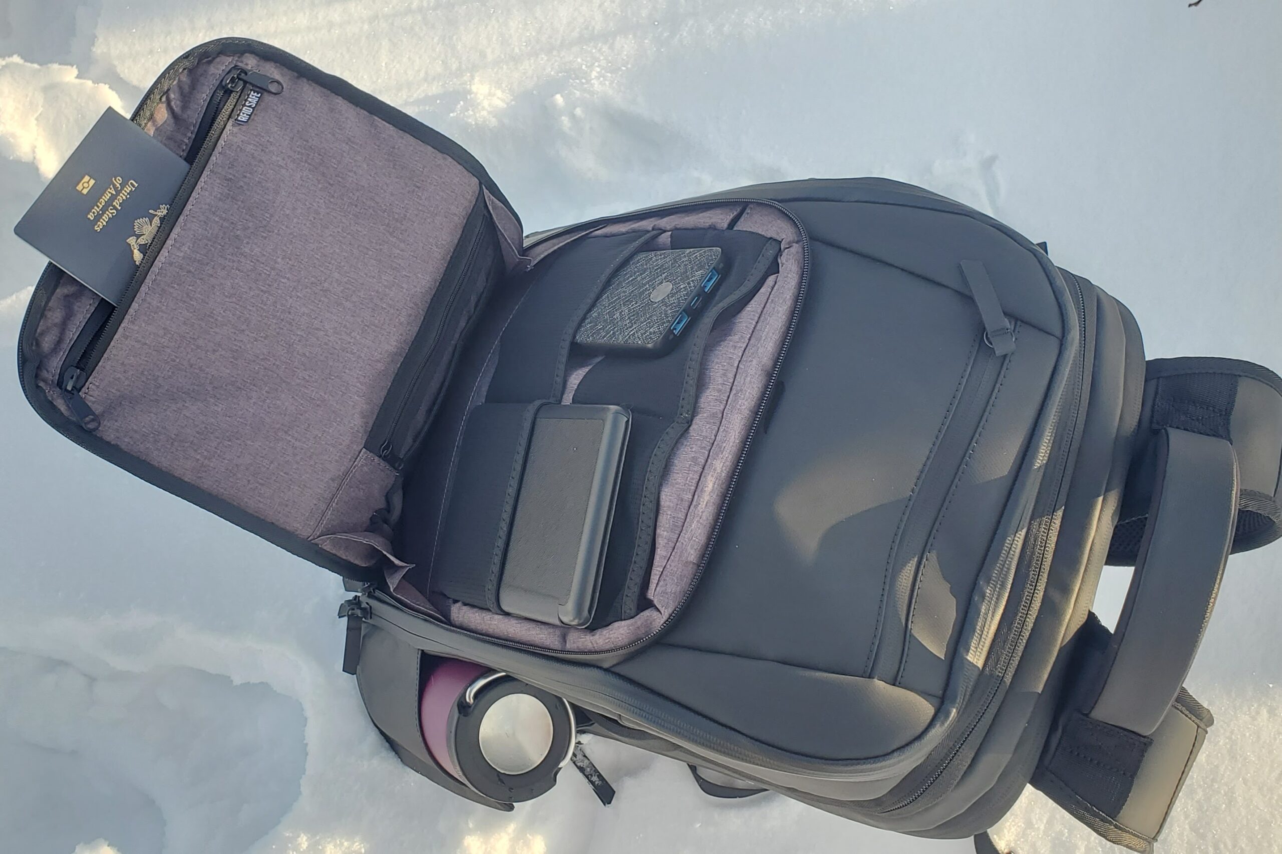 A closeup of the outer pocket of a backpack showing contents organized.