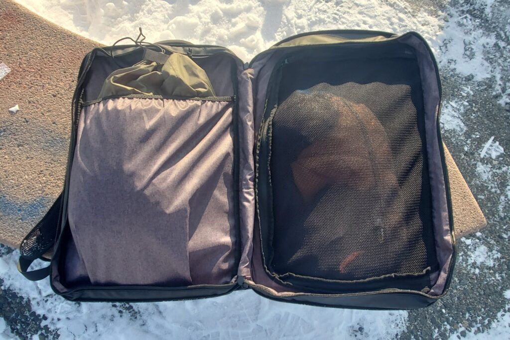 A closeup of the mesh dividers on the inside of a travel backpack.