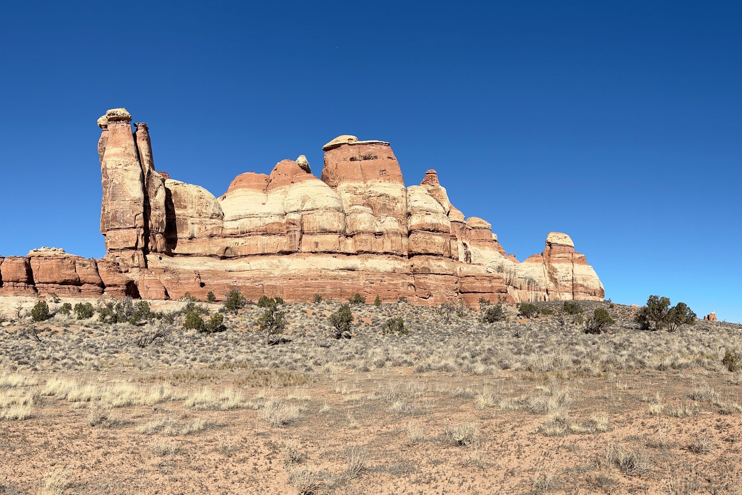 Towering red rocks on a cloudless day in Canyonlands National Park