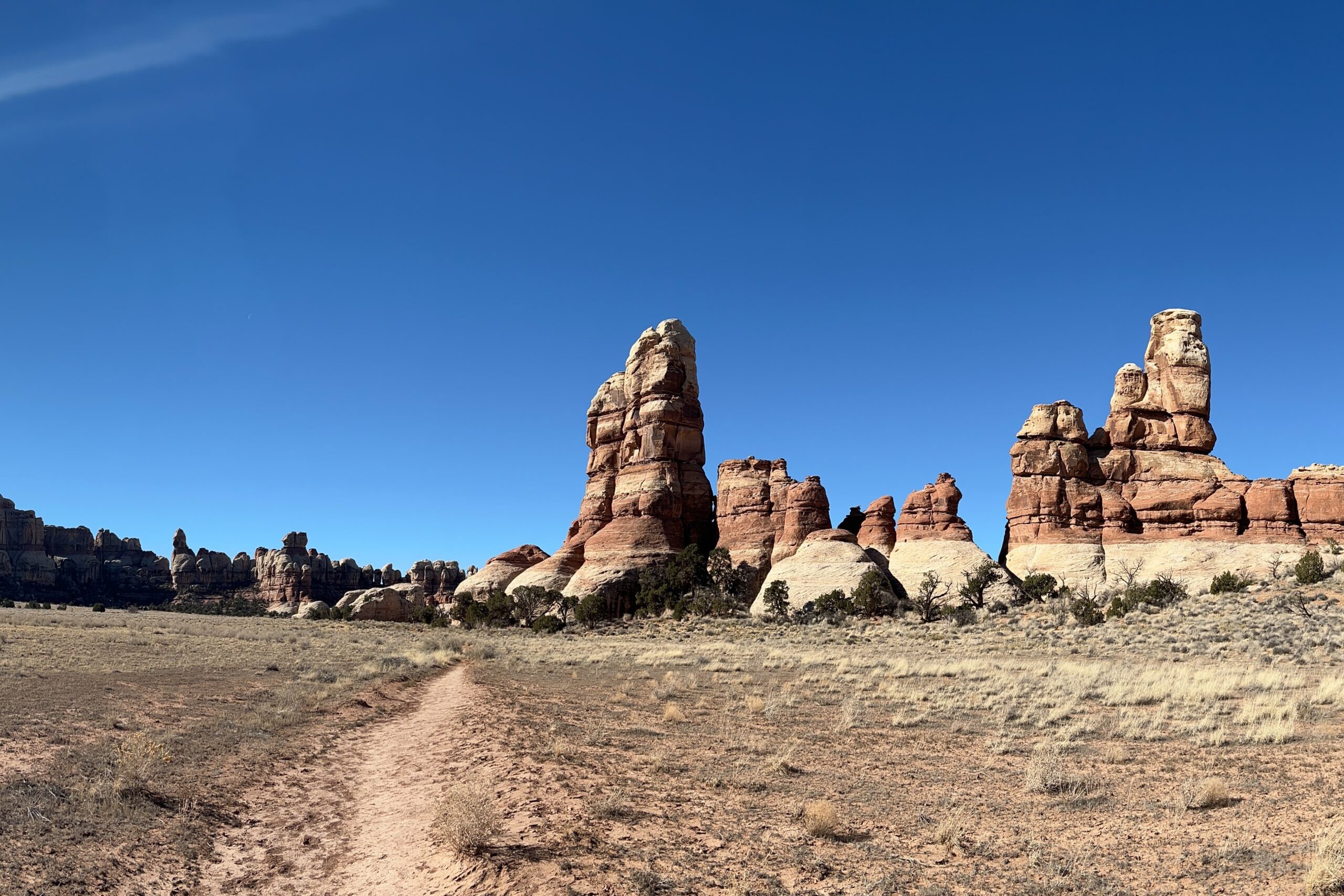 Towering red rocks on a cloudless day in Canyonlands National Park