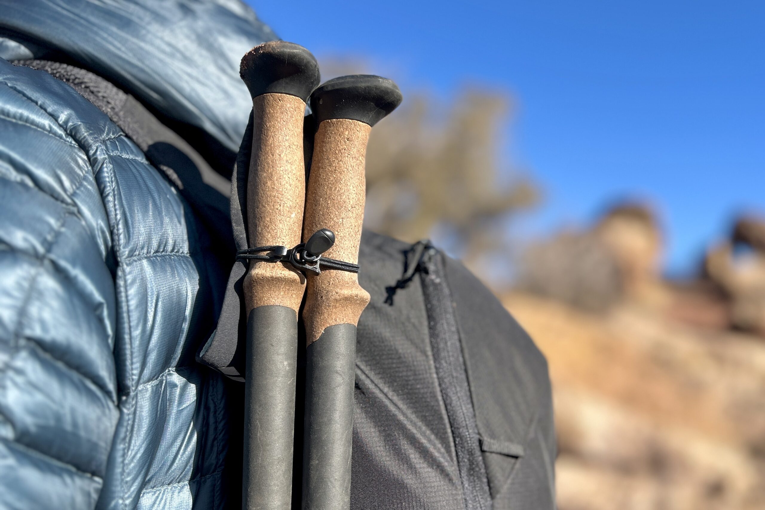 Close-up image of the top of a pair of hiking poles attached to a daypack.