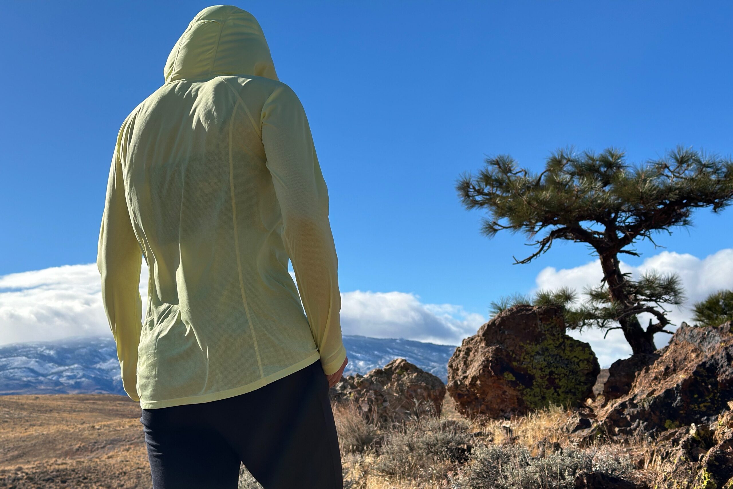 woman hiking with pack on in high desert landscape