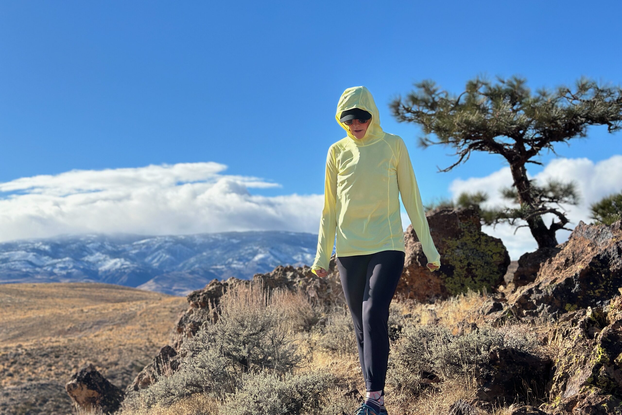 woman hiking with pack on in high desert landscape