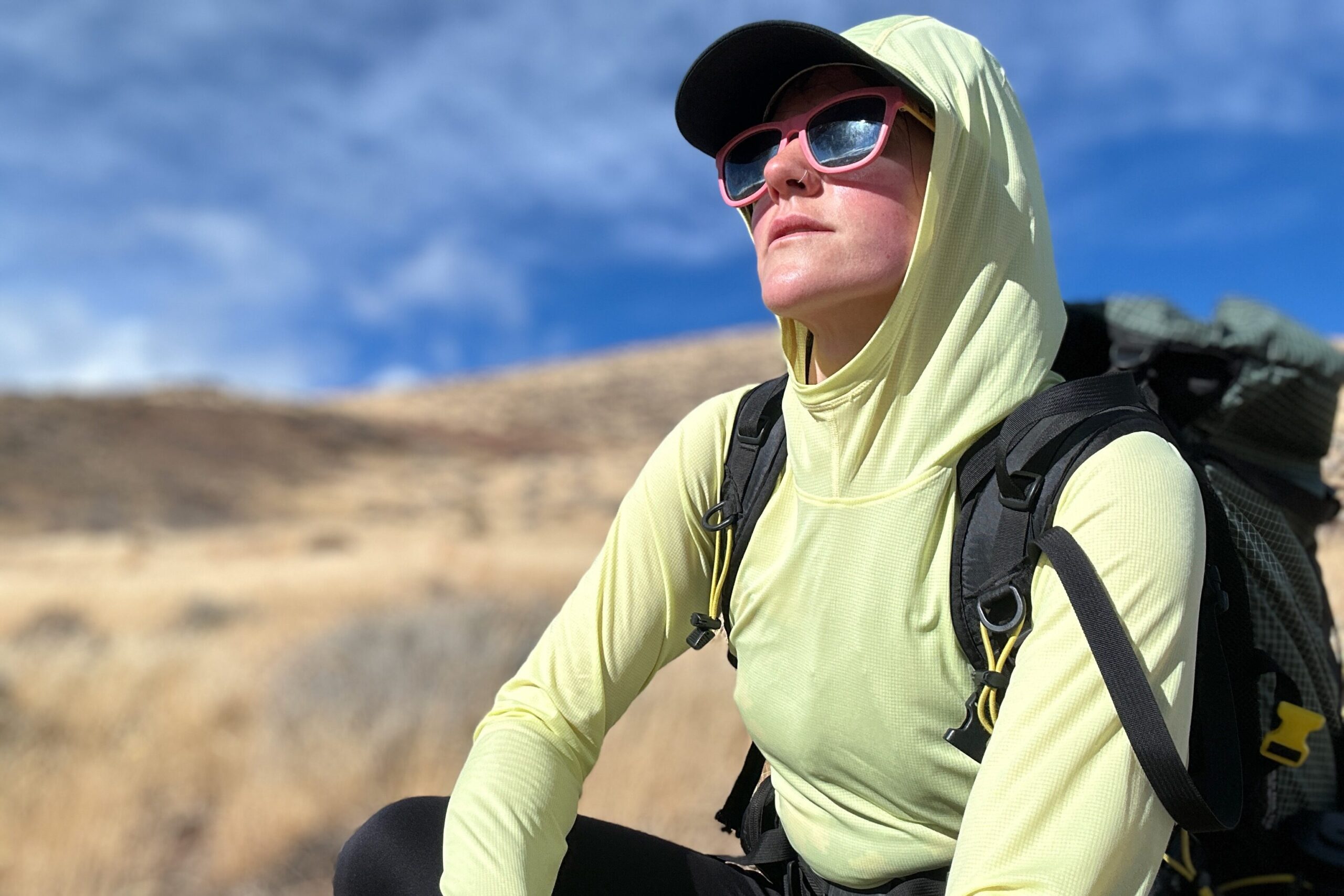 woman hiking with pack on in high desert landscape